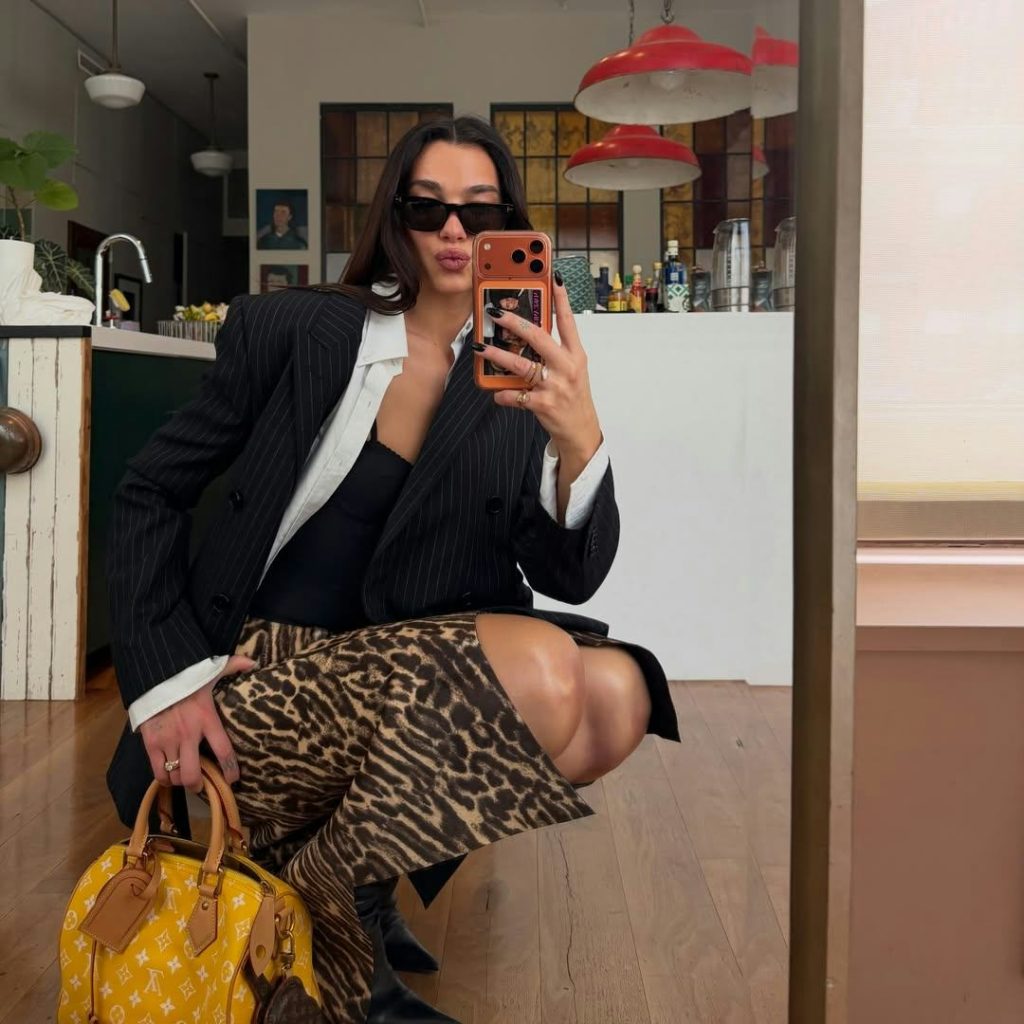 Dua Lipa Boosts High-Contrast Prints With A High-Voltage Speedy Bag